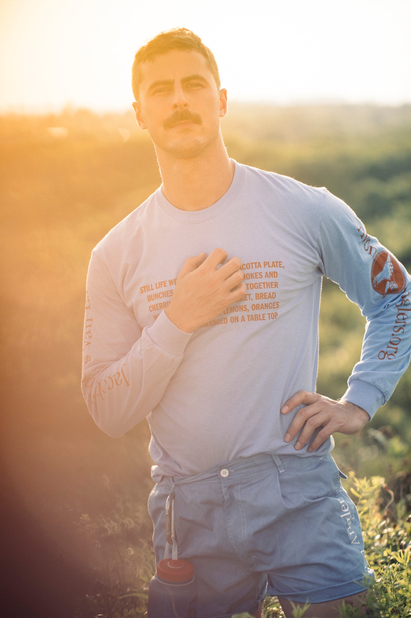Model Nico Brown wearing sky blue Avon Anglers x Foppens long sleeve t-shirt and blue wash re-wear shorts